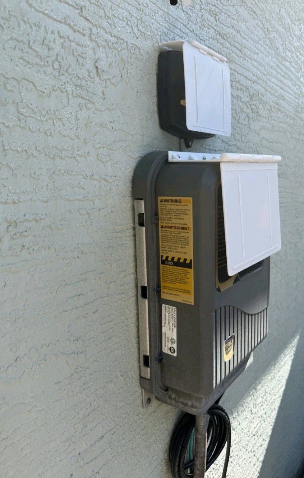 Customer installation side view showing MRKSENS hinged covers open on Jandy JEP-R controller and TruClear Power Center