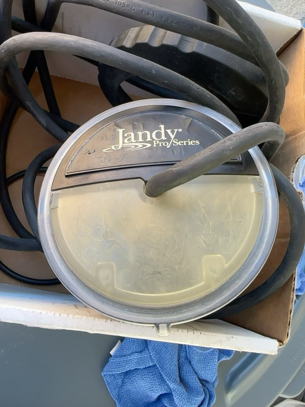 Weathered Jandy TruClear salt cell with a yellowed and clouded clear inspection window